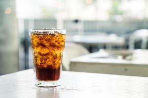 Iced cola glass on the table photo