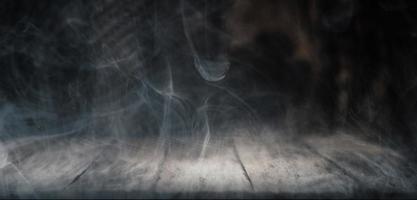 Smoke on dark wood background photo