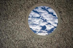 Soft Clouds on Blue Sky on the Window photo