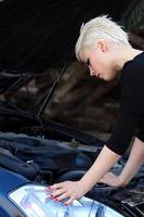 Blond Woman Repairs the Car photo