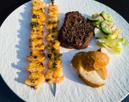 Surf and turf fillet steak and white tiger prawns photo