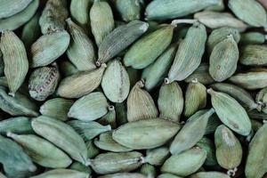 green cardamom on olive wood photo