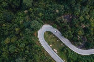 mountain road and green trees from above photo