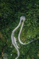 mountain road and green trees from above photo