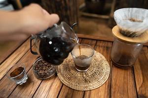 drip coffee on a wooden table at home photo