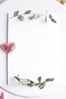 Background with copy space blank on table, glitter heart, eucalyptus photo