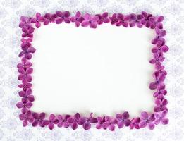 Background with copy space blank on table with lilac purple flower.