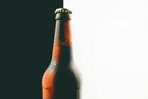 Close up photo of beer bottle over white and black background