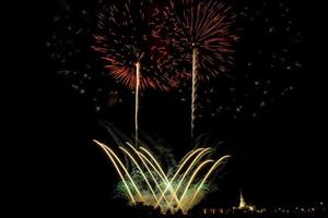 Huge, colorful fireworks over the rice fields at dusk. photo