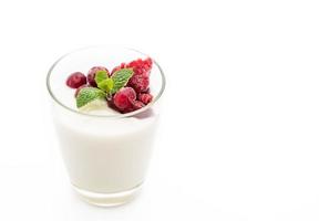 Yogurt with mixed berries on white background photo