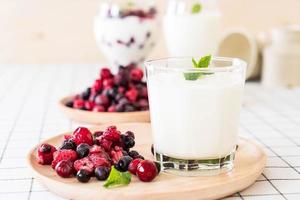 Yogurt with mixed berries on the table photo