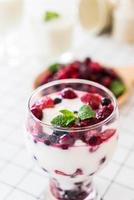 Yogurt with mixed berries on the table photo