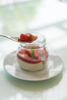 Homemade dessert panna cotta with strawberry sauce photo