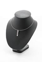 Beautiful and luxury necklace with jewelry stand neck on white photo