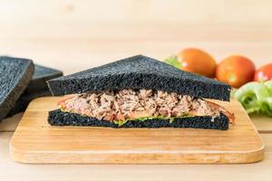 Tuna charcoal sandwich on wood board photo