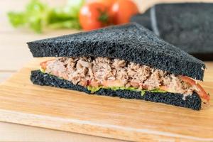 Tuna charcoal sandwich on wood board photo