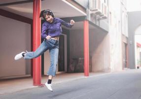 Happy young asian woman listening to music