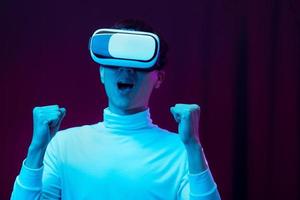 Young asian man wearing virtual reality goggle watching 360 degree vdo photo