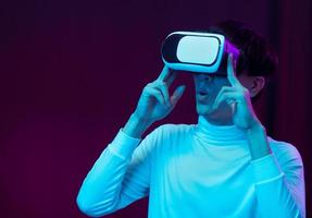 Young asian man wearing virtual reality goggle watching 360 degree vdo photo