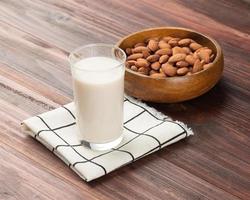 Almonds in wooden bowl on the table, Healthy snack, Vegetarian food photo