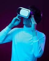 Young asian man wearing virtual reality goggle watching 360 degree vdo photo