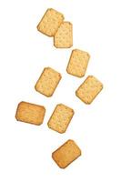 Cracker cookies falling isolated on white background photo