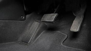 Man foot and accelerator and brake pedal inside the car photo