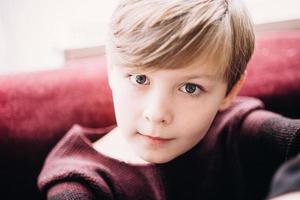 A closeup portrait of a cute kid boy with grey eyes photo