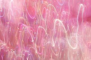 Abstract background of lights glowing pink with colorful strokes photo