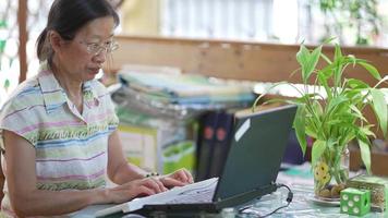 Senior woman typing on keyboard and using computer to write email video