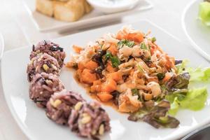 Spicy vegan salad with sticky berry and grain rice photo