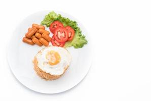 Fried rice with sausage and fried egg on the table photo