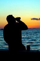 People Silhouette and the Sea in Sunset photo