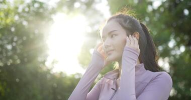 Woman in Sportwear Standing and Listen to Music video