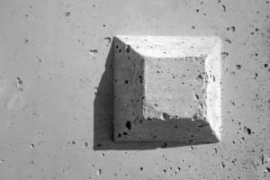 The truncated square pyramid shape on the concrete surface photo