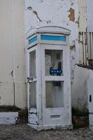 Old telephone booth that still survives in a city photo