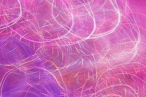 Abstract background of lights glowing pink with colorful strokes photo