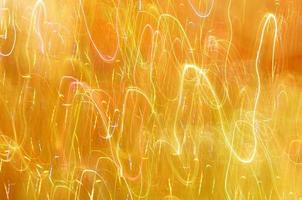 Abstract background of lights glowing yellow with colorful strokes photo