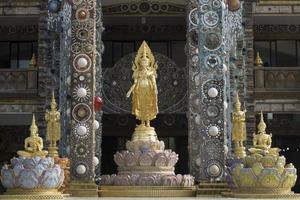 golden buddha statues in front of shrine photo