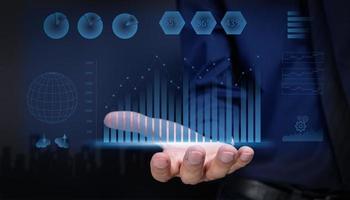 businessman showing hologram display stock investment growth graph