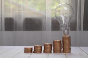 coins stacked together investment ideas stocks financial growth  bulb photo