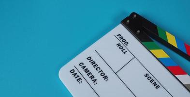 Clapperboard or movie slate on blue background. photo
