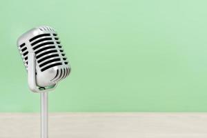 Microphone retro with copy space on table and greed background photo