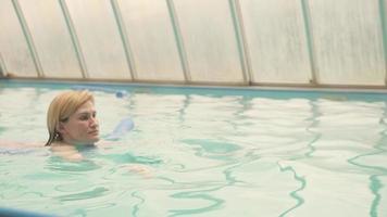 Woman swimming in a pool photo