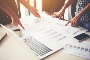 Business people at work on stock market charts in office. Meeting. photo