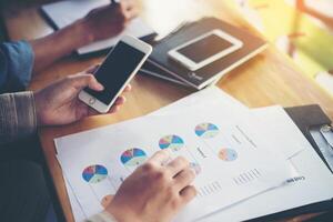 business woman hand working on smart phone with  business graph. photo