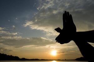 hand shaped bird fly on the sun sky morning photo