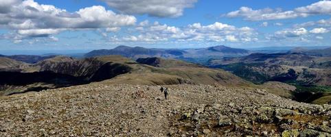 Hikers following the track off the summit photo