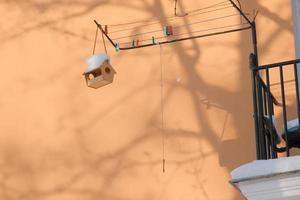 wooden birdhouse for small wintering birds in the cold winter outdoor photo