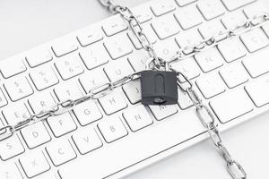 Computer Security concept. Chain and padlock on keyboard photo